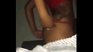 2 asian girls kissing spitting patting while getting undressed on the couch in the roo